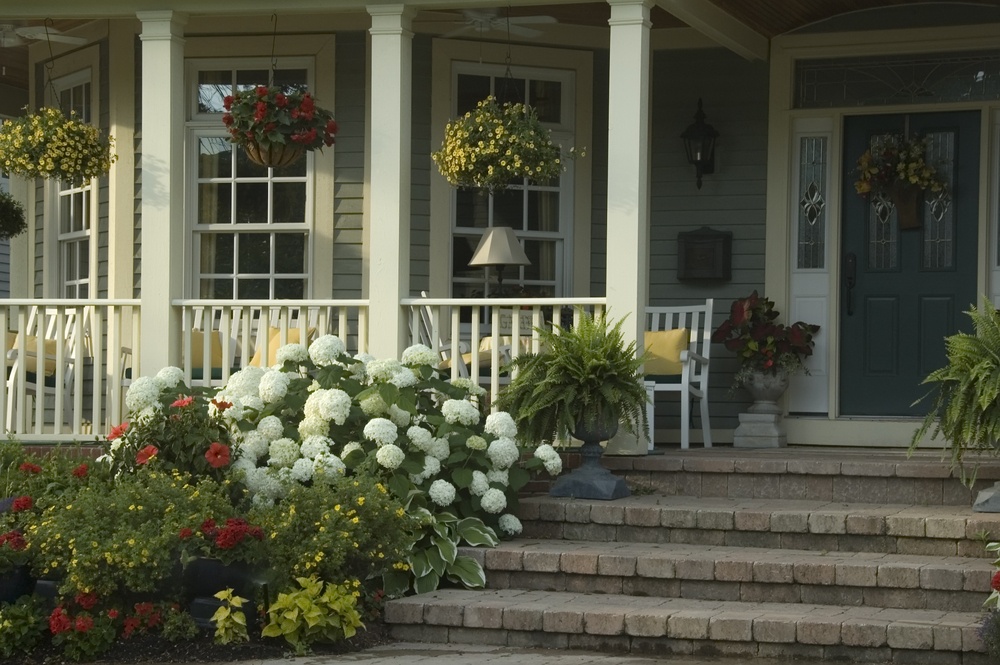 glow-of-summer-sunrise-on-front-porch-of-suburban-house